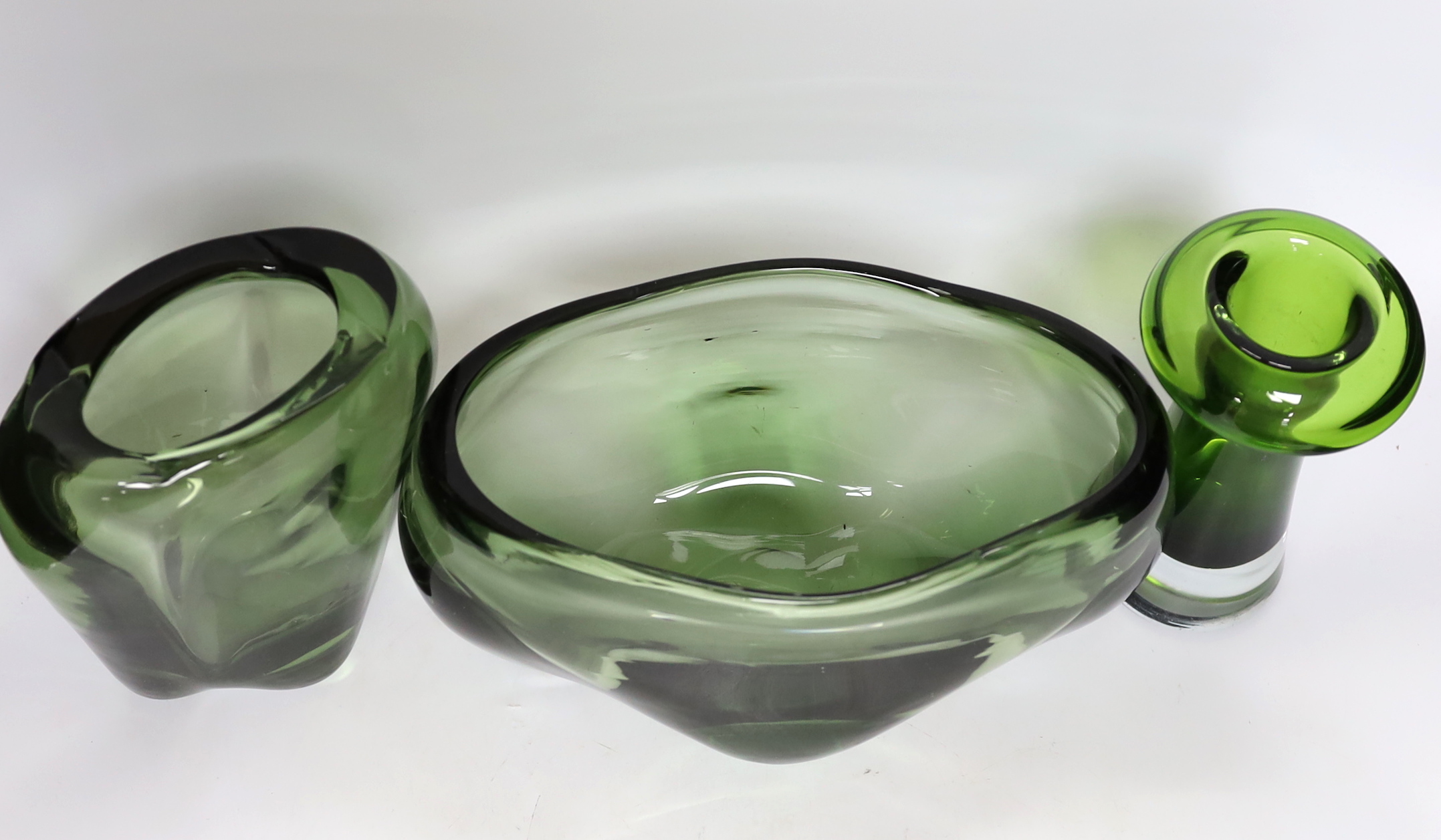 Two Whitefriars green glass vases, designed by James Hogan, and one other, largest 27cm wide